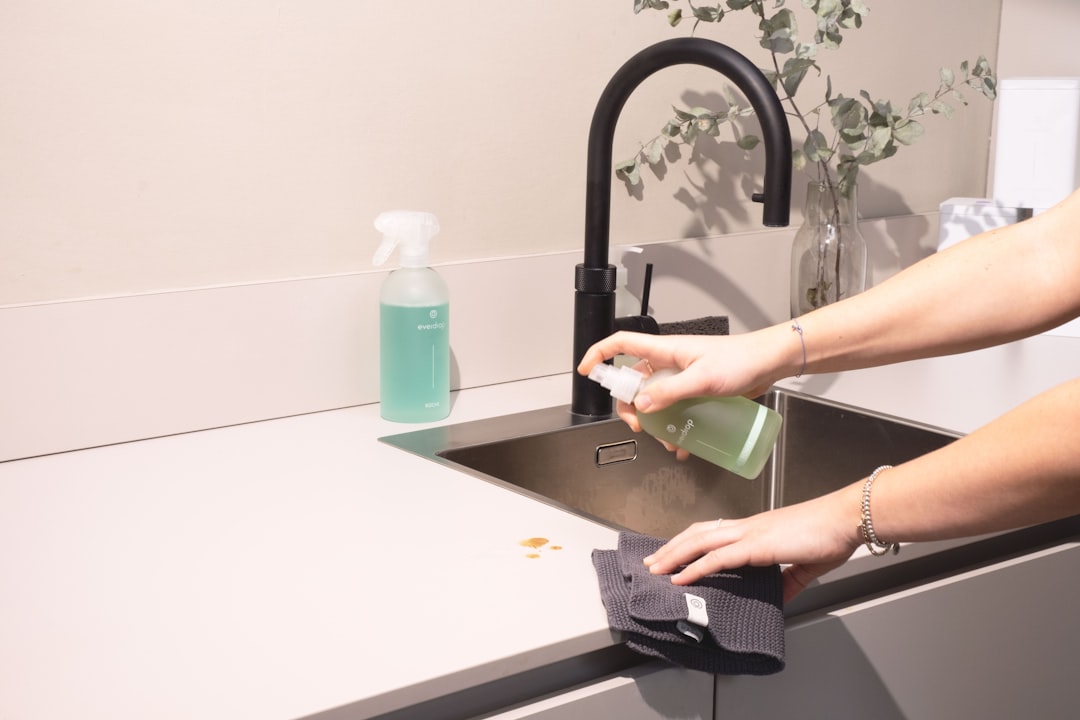 services-03 a-woman-is-cleaning-a-kitchen-sink-with-a-rag-sqomdoqb3ws